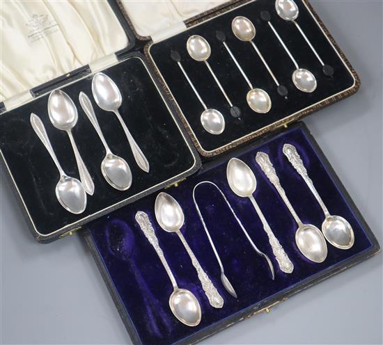 A cased set of six George V silver bean end coffee spoons and two other part cased sets of silver spoons.